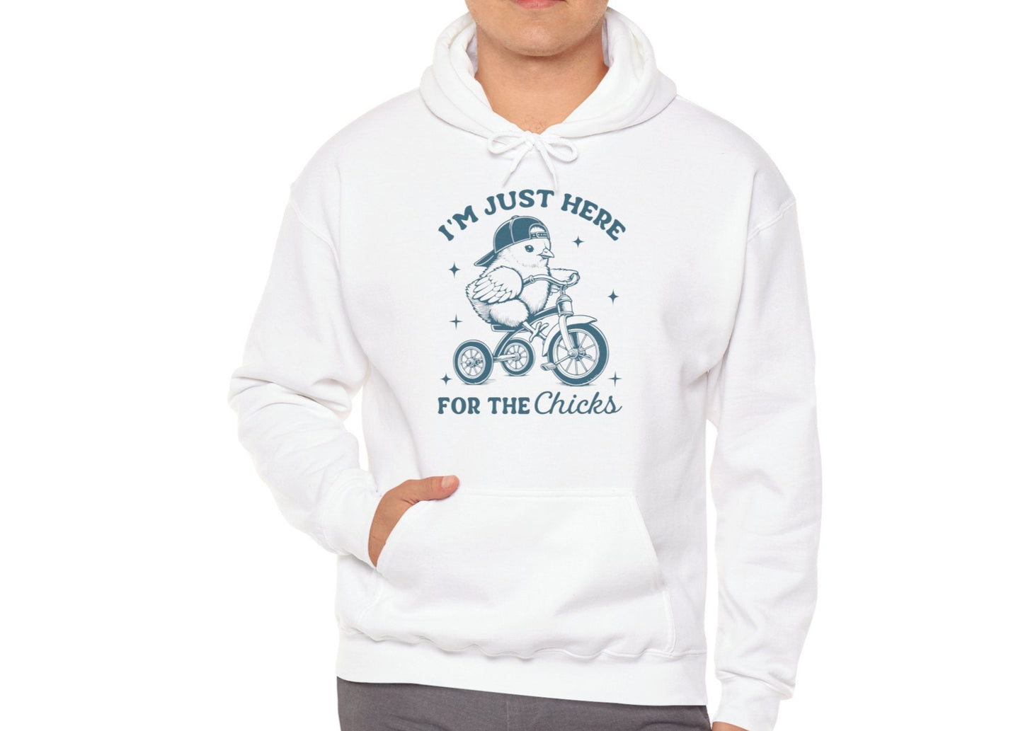 Man modeling white hoodie with playful Easter chick graphic. Part of the Vivid Divergence Sensory Friendly Unisex Hoodies Range.