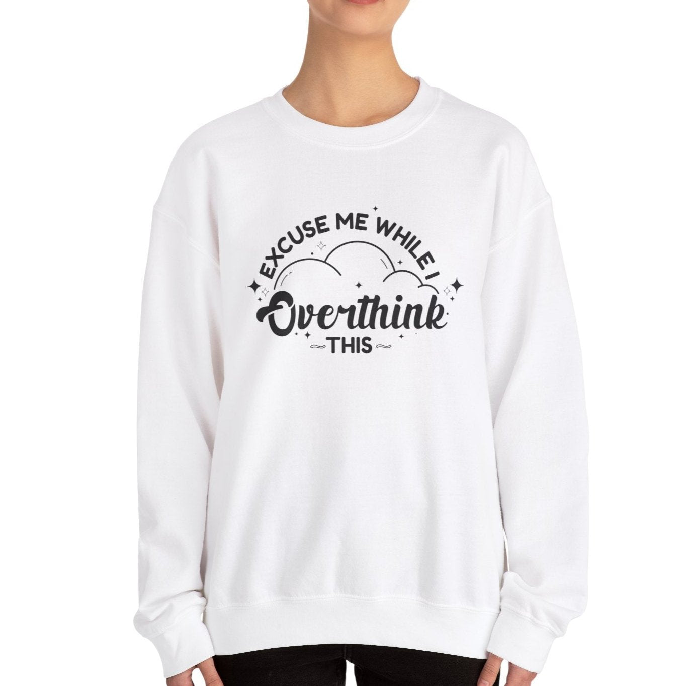 Model wearing a white sweater jumper with the text "Excuse Me While I Overthink This" in black lettering. Part of the Vivid Divergence Sensory Friendly Unisex Sweater Jumper Range.