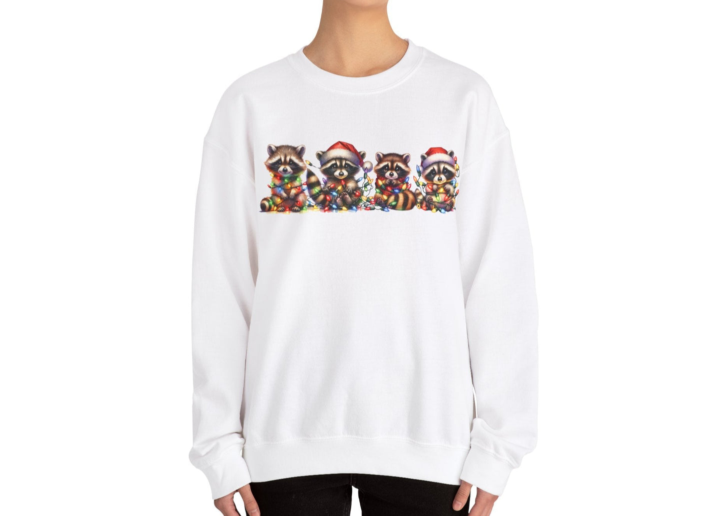Model wearing a beige sweatshirt featuring a festive illustration of raccoons in Christmas attire causing holiday chaos. Part of the Vivid Divergence Sensory Friendly Unisex Sweater Jumper Range.