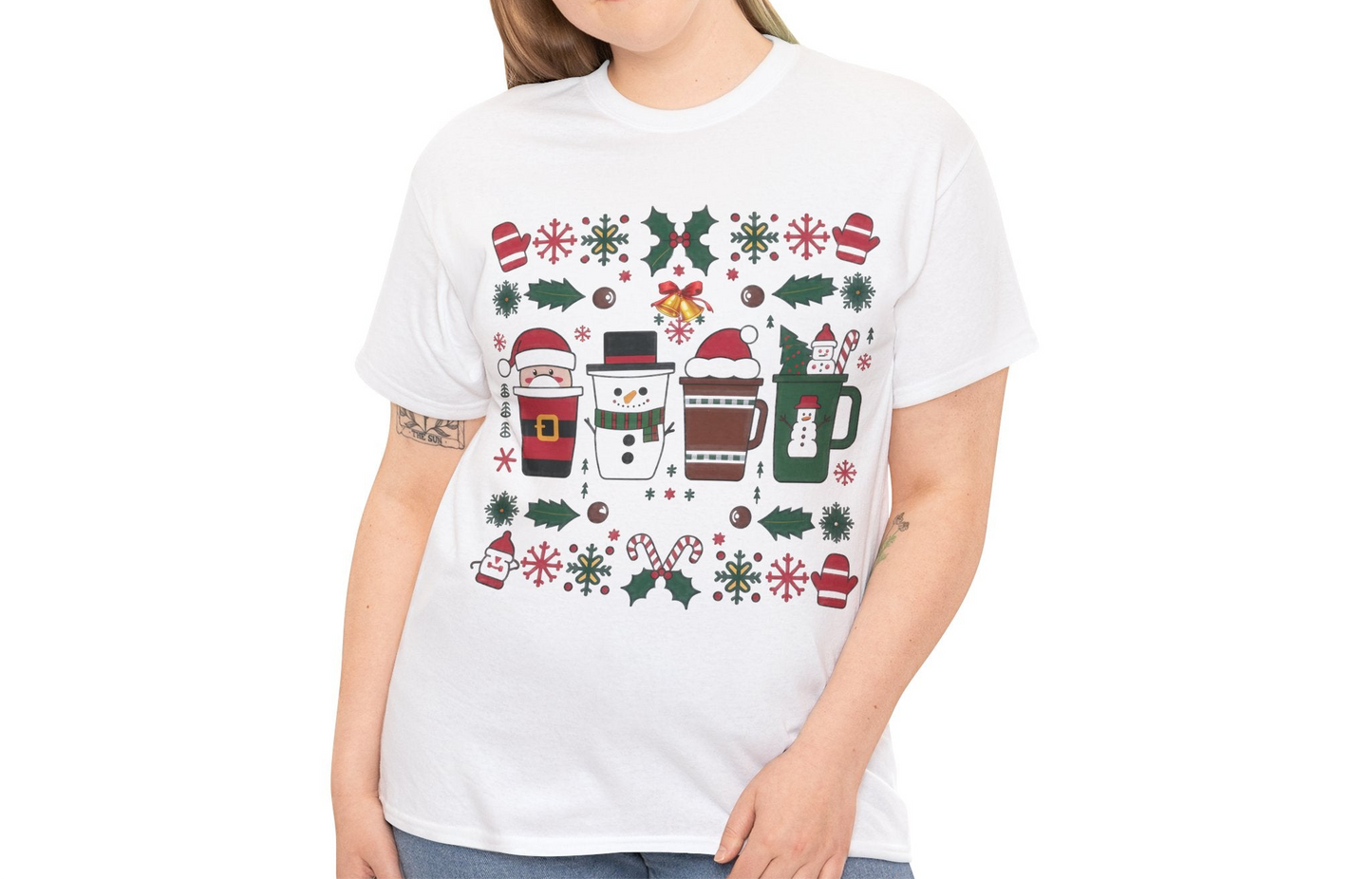 Close-up of a white T-shirt featuring a festive holiday pattern with coffee cups, snowflakes, and Christmas elements, highlighting the intricate design details. Part of the Vivid Divergence Sensory Friendly Unisex Tees Range.