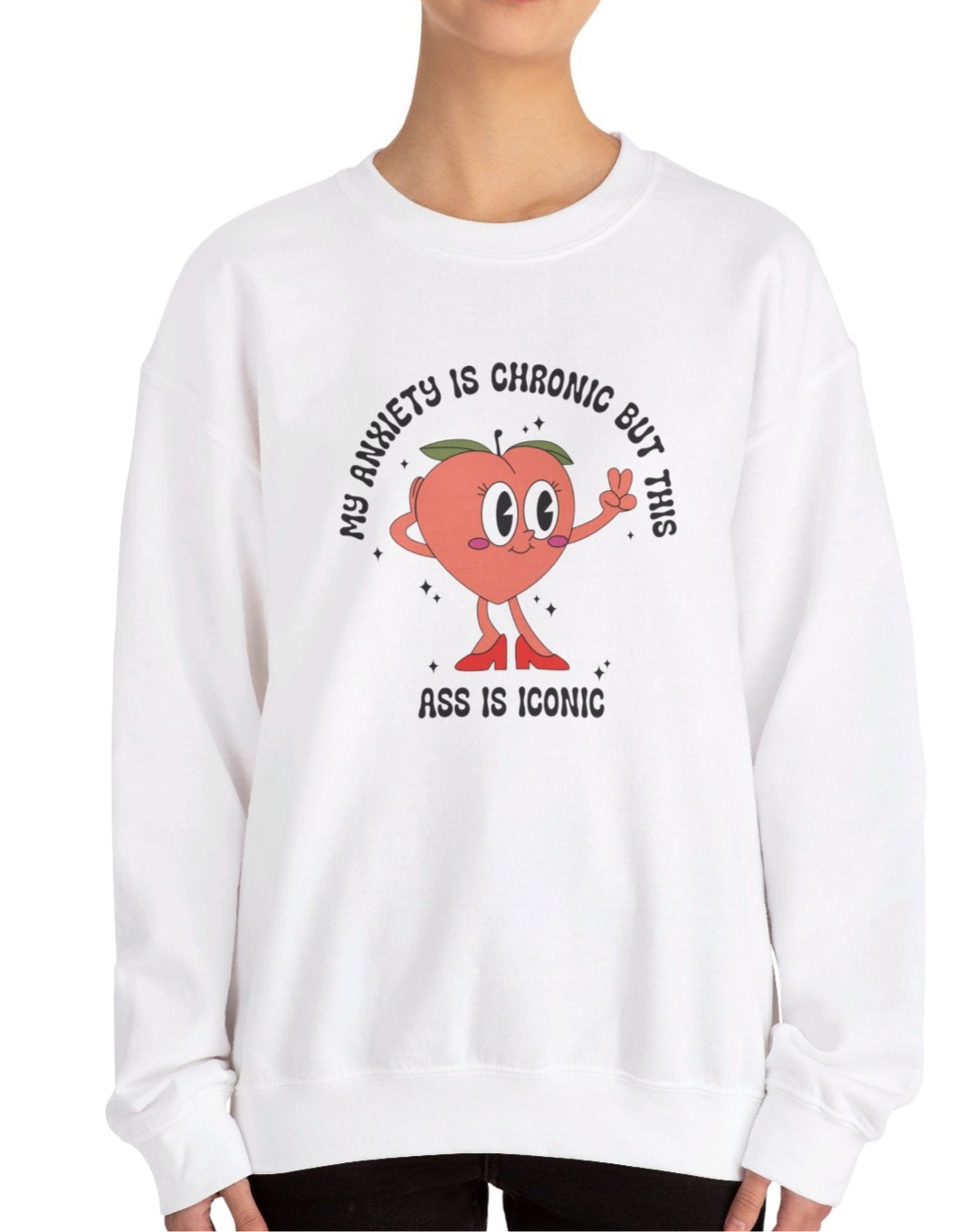 Model wearing a white sweater jumper with the text "My anxiety is chronic but this ass is iconic" and a cartoon peach illustration. Part of the Vivid Divergence Sensory Friendly Unisex Sweater Jumper Range.