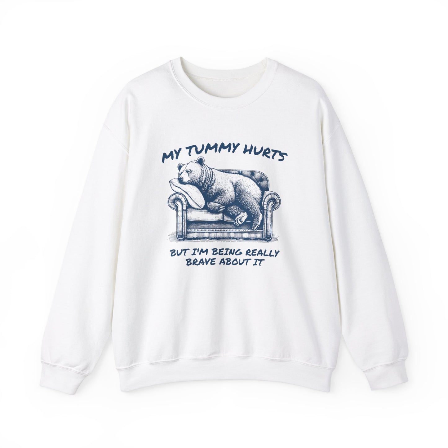 Front view of a white sweater jumper with the text "My Tummy Hurts But I’m Being Really Brave About It" and a cartoon illustration of a bear holding its stomach. Part of the Vivid Divergence Sensory Friendly Unisex Sweater Jumper Range.