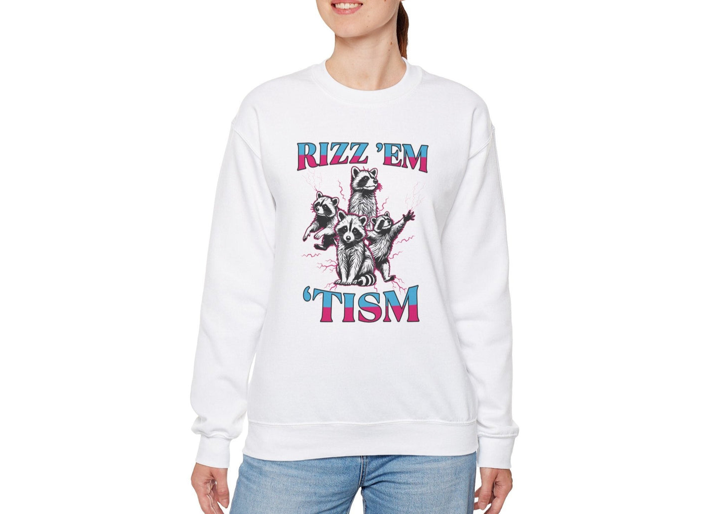 Model wearing a white sweater jumper with the text "Rizz 'Em 'Tism" and a cartoon raccoon illustration striking a pose. Part of the Vivid Divergence Sensory Friendly Unisex Sweater Jumper Range.