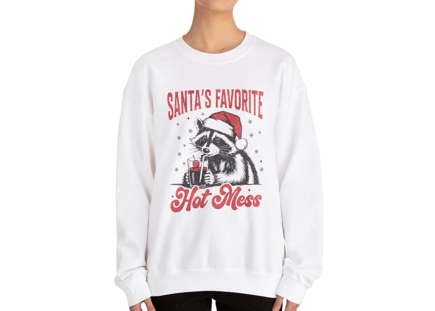 Model wearing a white sweatshirt featuring a "Santa's Favorite Hot Mess" design with a festive raccoon wearing a Santa hat. Part of the Vivid Divergence Sensory Friendly Unisex Sweater Jumper Range.