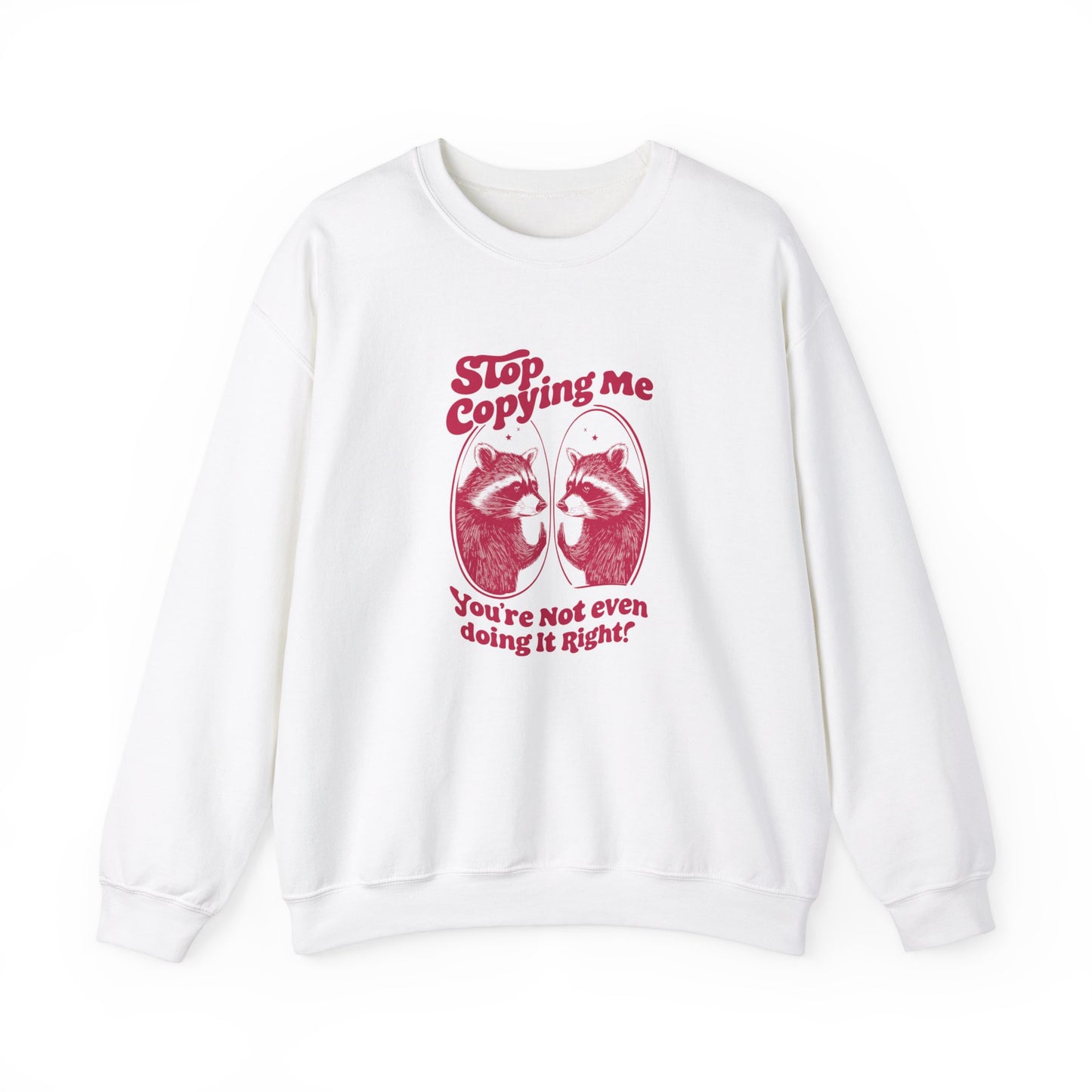 Front view of a white sweater jumper with the text "Stop Copying Me, You’re Not Even Doing It Right," featuring a cartoon raccoon looking in a mirror. Part of the Vivid Divergence Sensory Friendly Unisex Sweater Jumper Range.