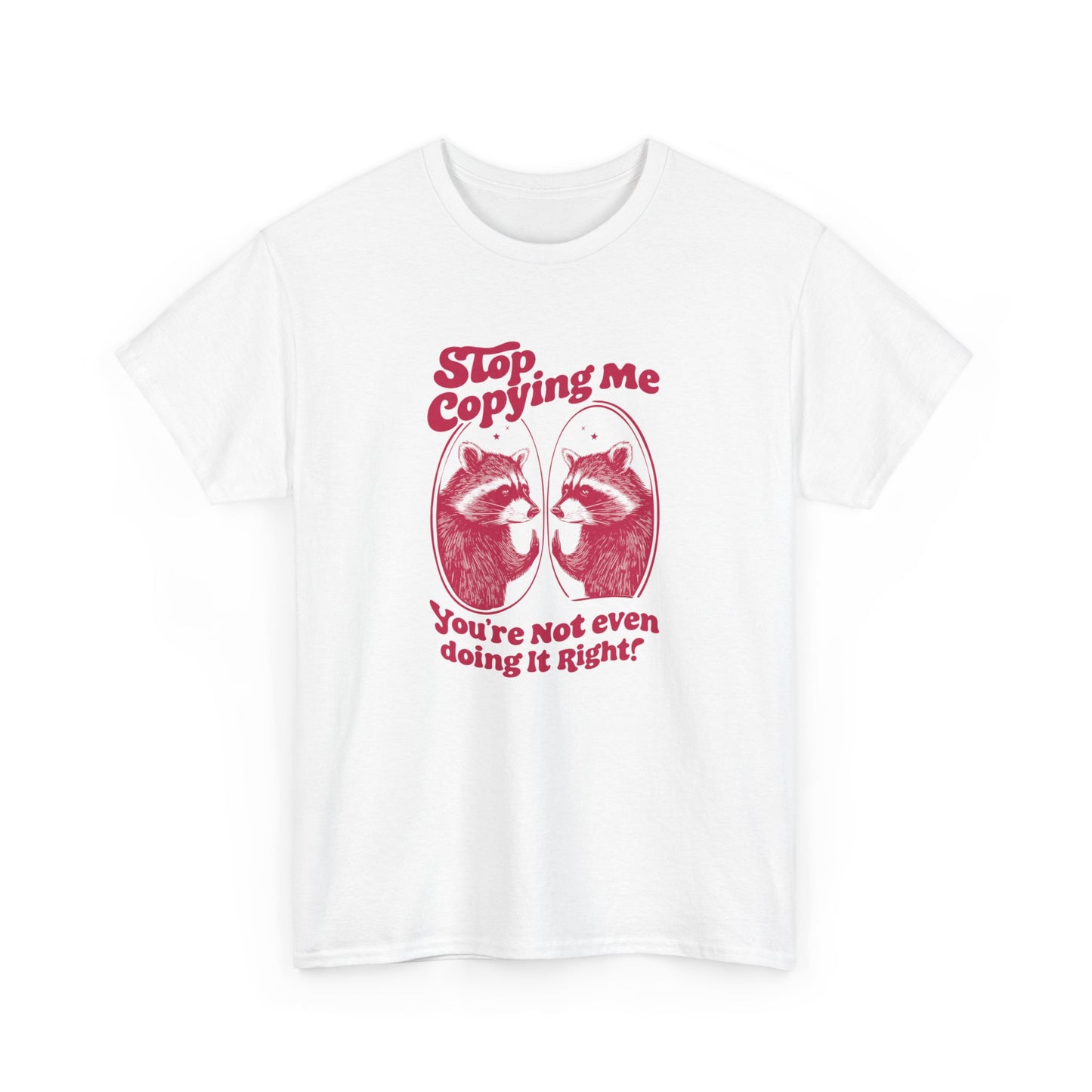 Front view of a white T-shirt with "Stop Copying Me" in bold red text and a mirrored raccoon graphic, featuring the tagline "You're Not Even Doing It Right!" Part of the Vivid Divergence Sensory Friendly Unisex Tees Range.