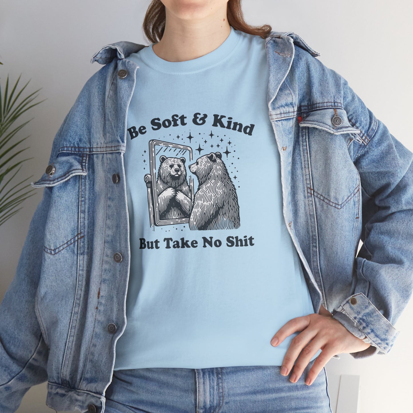 Woman in blue T-shirt layered with denim jacket featuring the bear design. Dressed for self-care and conflict resolution. Part of the Vivid Divergence Memewear Collection!
