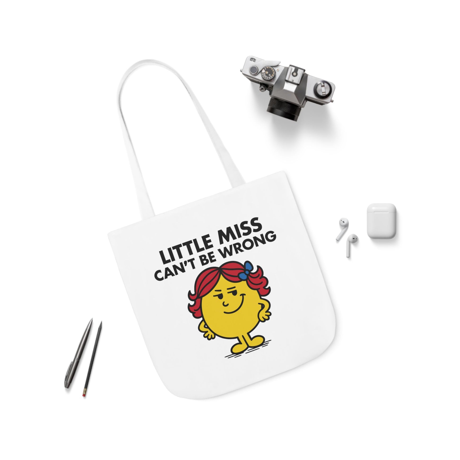 Flat lay of canvas tote bag with Little Miss Can’t Be Wrong design surrounded by minimal accessories. Even her tote has opinions. Part of the Vivid Divergence Little Miss Meme Collection!
