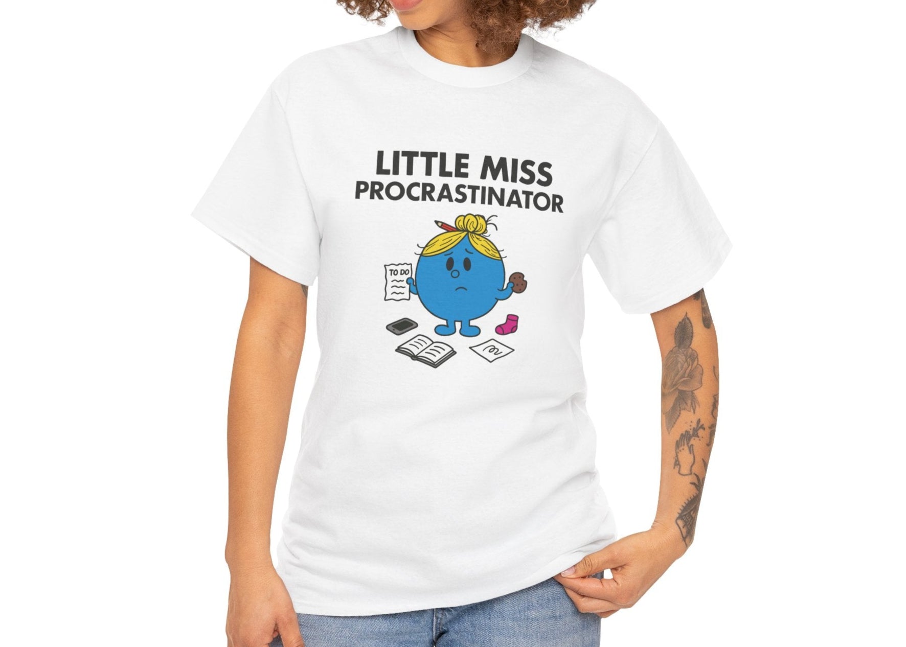 Person wearing the Little Miss Procrastinator T-shirt with casual jeans. Part of the Little Miss Meme Character Collection. A Vivid Divergence Sensory Friendly Unisex Tee.
