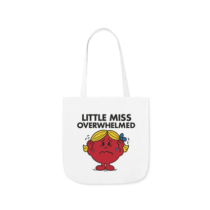 Front view of white canvas tote bag featuring red character with hands on her head, wide eyes, and sweat droplets under the text "Little Miss Overwhelmed." One minor task away from a full breakdown. Part of the Vivid Divergence Little Miss Meme Collection!

