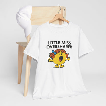 Little Miss Oversharer T-shirt draped over a chair in a minimalist setting. Part of the Little Miss Meme Character Collection. A Vivid Divergence Sensory Friendly Unisex Tee.
