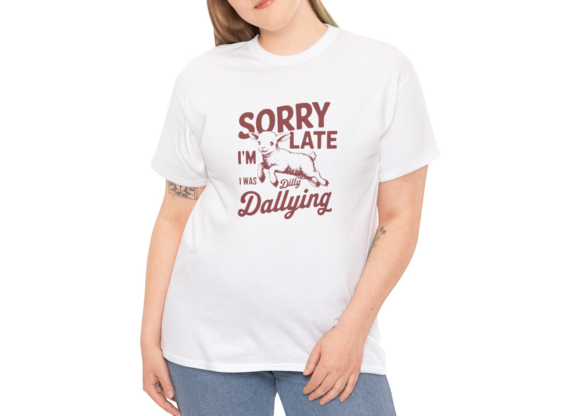 Woman smiling while wearing the white “Sorry I’m Late I Was Dilly Dallying” T-shirt. She took her time, and it was worth it. Part of the Vivid Divergence Memewear Collection!
