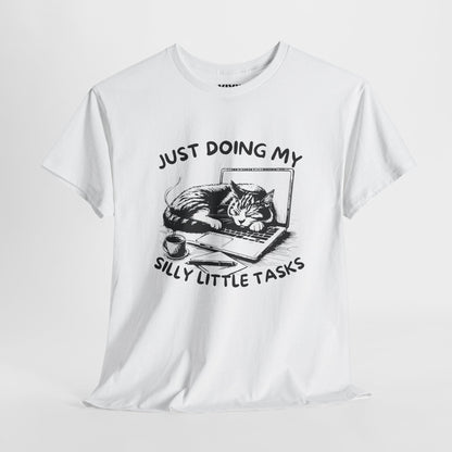 ite T-shirt with cat-laptop graphic hanging on a hanger. Aesthetic minimalism meets passive rebellion. Part of the Vivid Divergence Memewear Collection!