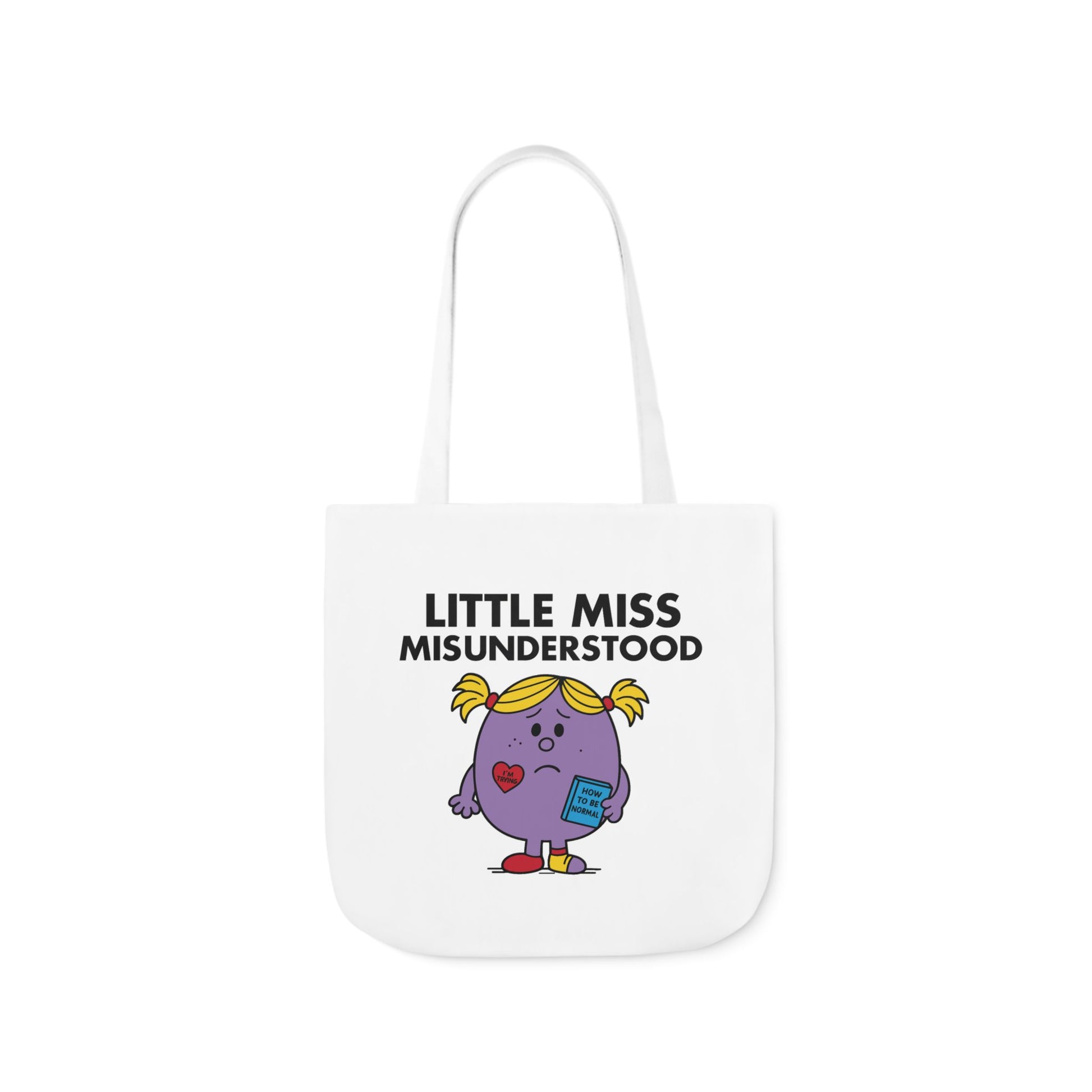 Front view of white canvas tote bag featuring purple character with yellow pigtails, teary eyes, and a pout beneath the text "Little Miss Misunderstood." She just wanted to be heard. Part of the Vivid Divergence Little Miss Meme Collection!
