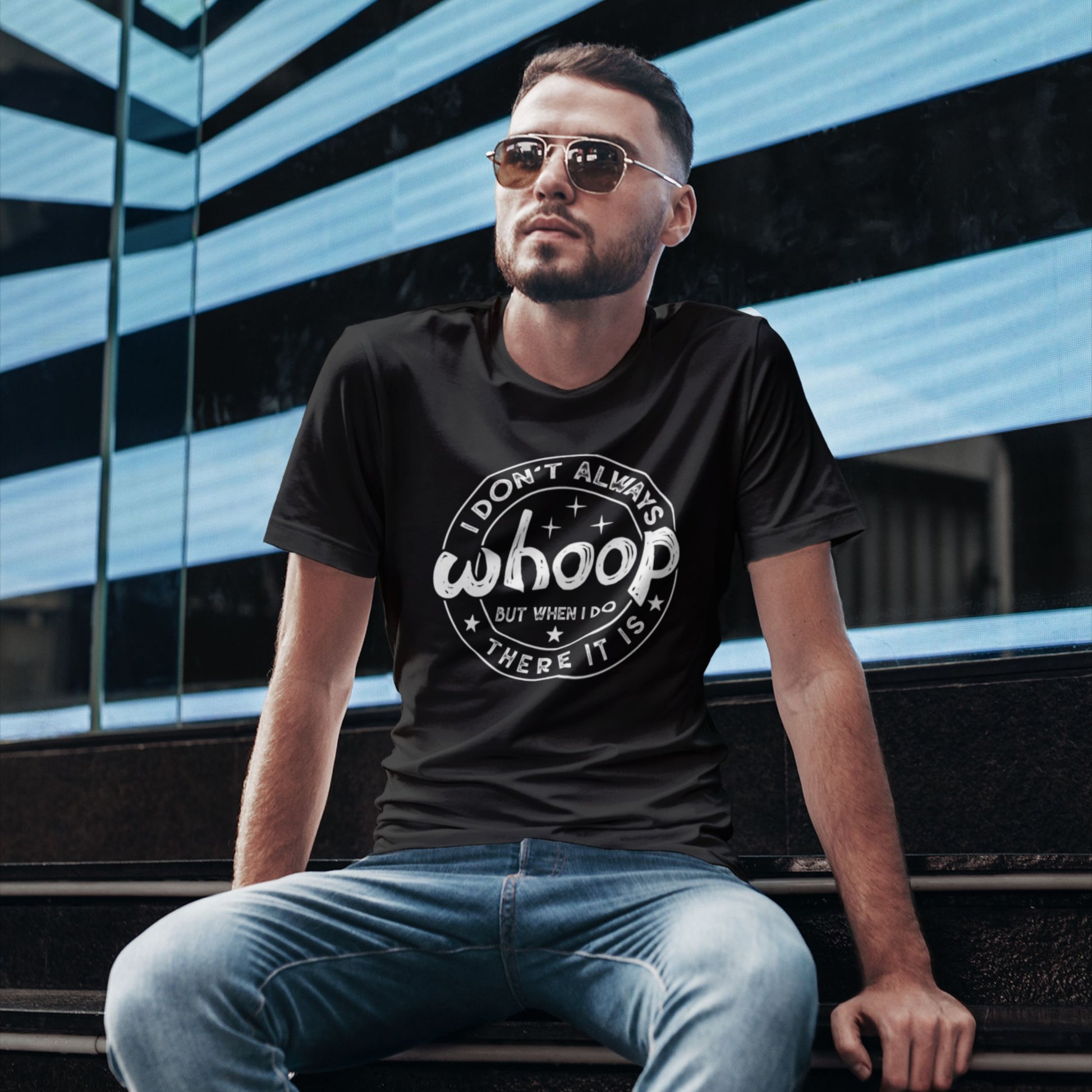 Black retro graphic Unisex T-shirt with "I Don't Always Whoop But When I Do There It Is" white text design, worn by male model sitting outside for display. Part of the Vivid Divergence Sensory-Friendly But Fun Tee Collection.
