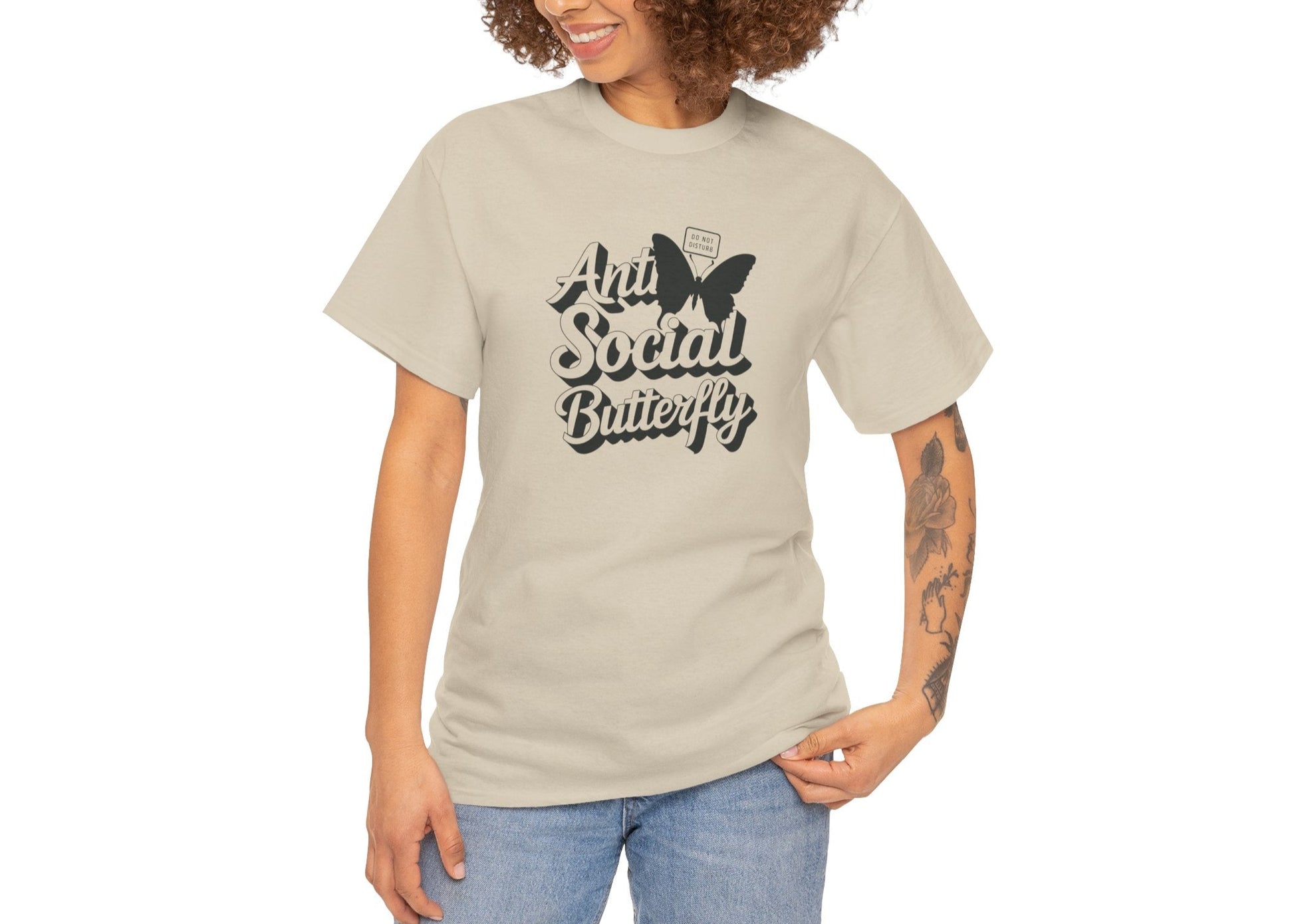 Woman modeling beige Anti-Social Butterfly T-shirt with casual smile. Outgoing energy? Not today. Part of the Vivid Divergence Memewear Collection!
