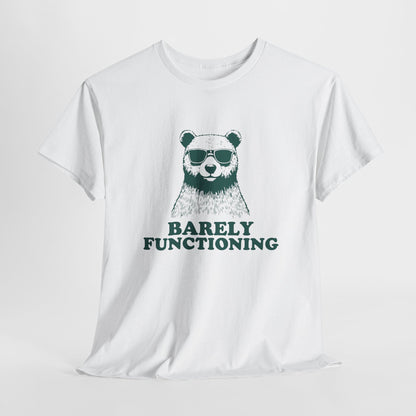 Hanging white T-shirt with a green bear graphic and "Barely Functioning" text. Part of the Vivid Divergence Sensory Friendly Unisex Tees Range.