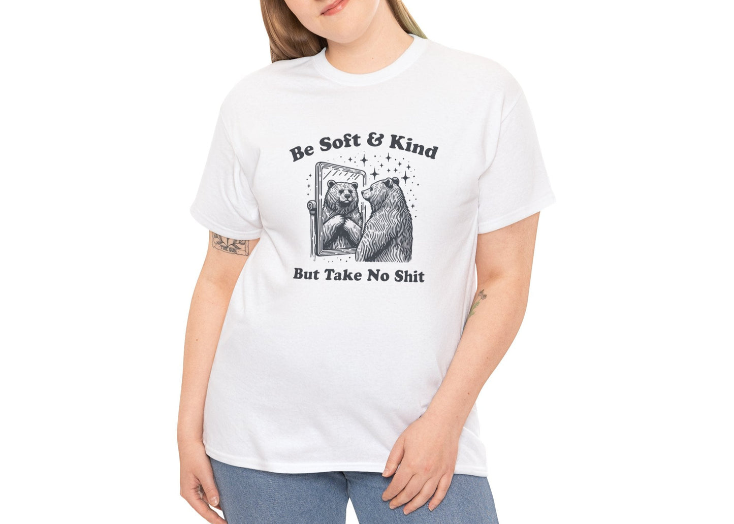 Woman in white T-shirt smiling while modeling the “Be Soft & Kind But Take No Shit” bear design. She’s nice, not naive. Part of the Vivid Divergence Memewear Collection!
