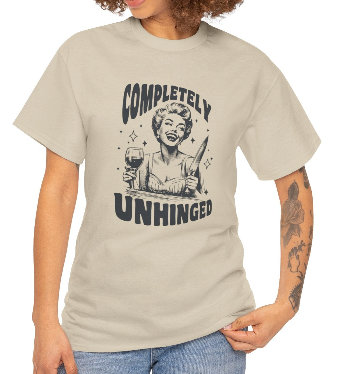 Model wearing a beige T-shirt with "Completely Unhinged" text and graphic design. Part of the Vivid Divergence Sensory Friendly Unisex Tees Range.