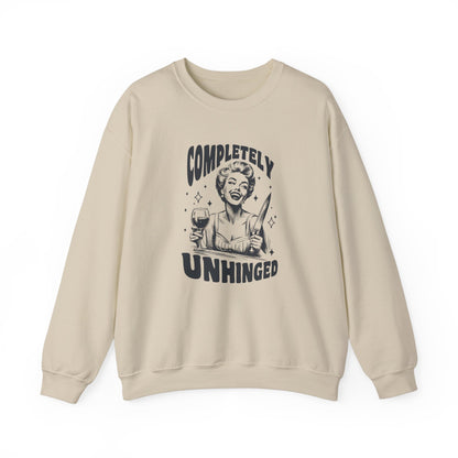 Front view of a beige sweatshirt featuring a graphic of a woman holding a knife and a glass of wine with the text "Completely Unhinged." Part of the Vivid Divergence Sensory Friendly Unisex Sweater Jumper Range.