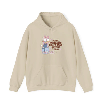 Front view of a beige hoodie featuring the text "Doing Fantastic, Didn’t Stab Anyone Today" and a cartoon illustration of a raccoon holding a knife. Part of the Vivid Divergence Sensory Friendly Unisex Hoodie Range.