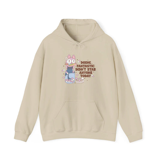 Front view of a beige hoodie featuring the text "Doing Fantastic, Didn’t Stab Anyone Today" and a cartoon illustration of a raccoon holding a knife. Part of the Vivid Divergence Sensory Friendly Unisex Hoodie Range.