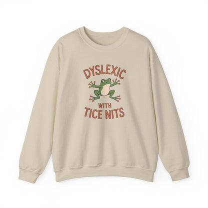 Front view of a beige sweatshirt featuring a cartoon frog and the text "Dyslexic with Tice Nits" in bold letters. Part of the Vivid Divergence Sensory Friendly Unisex Sweater Jumper Range.