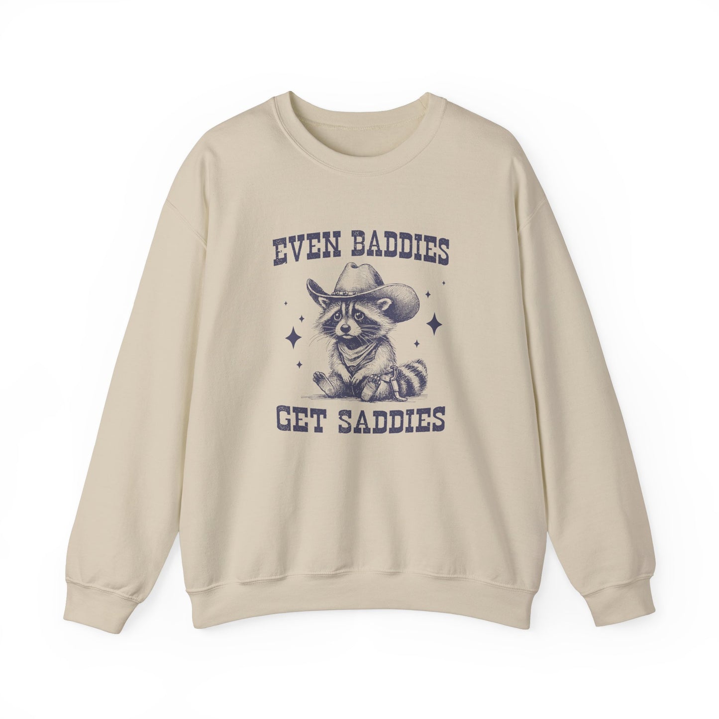Front view of a beige sweater jumper with the text "Even Baddies Get Saddies" and a cartoon raccoon illustration. Part of the Vivid Divergence Sensory Friendly Unisex Sweater Jumper Range.
