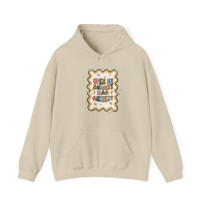 Front view of a beige hoodie with the text "Even My Anxiety Has Anxiety" surrounded by a decorative frame design. Part of the Vivid Divergence Sensory Friendly Unisex Hoodie Range.