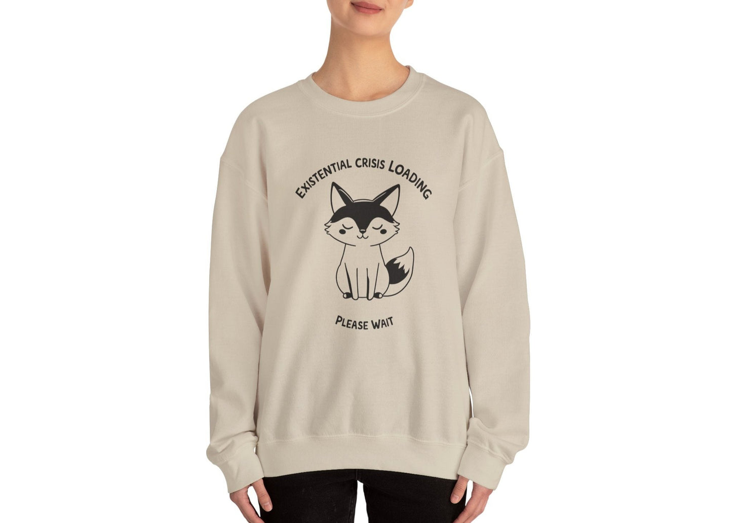 Model wearing a beige sweater jumper with the text "Existential Crisis Loading, Please Wait" and a cartoon fox illustration. Part of the Vivid Divergence Sensory Friendly Unisex Sweater Jumper Range.