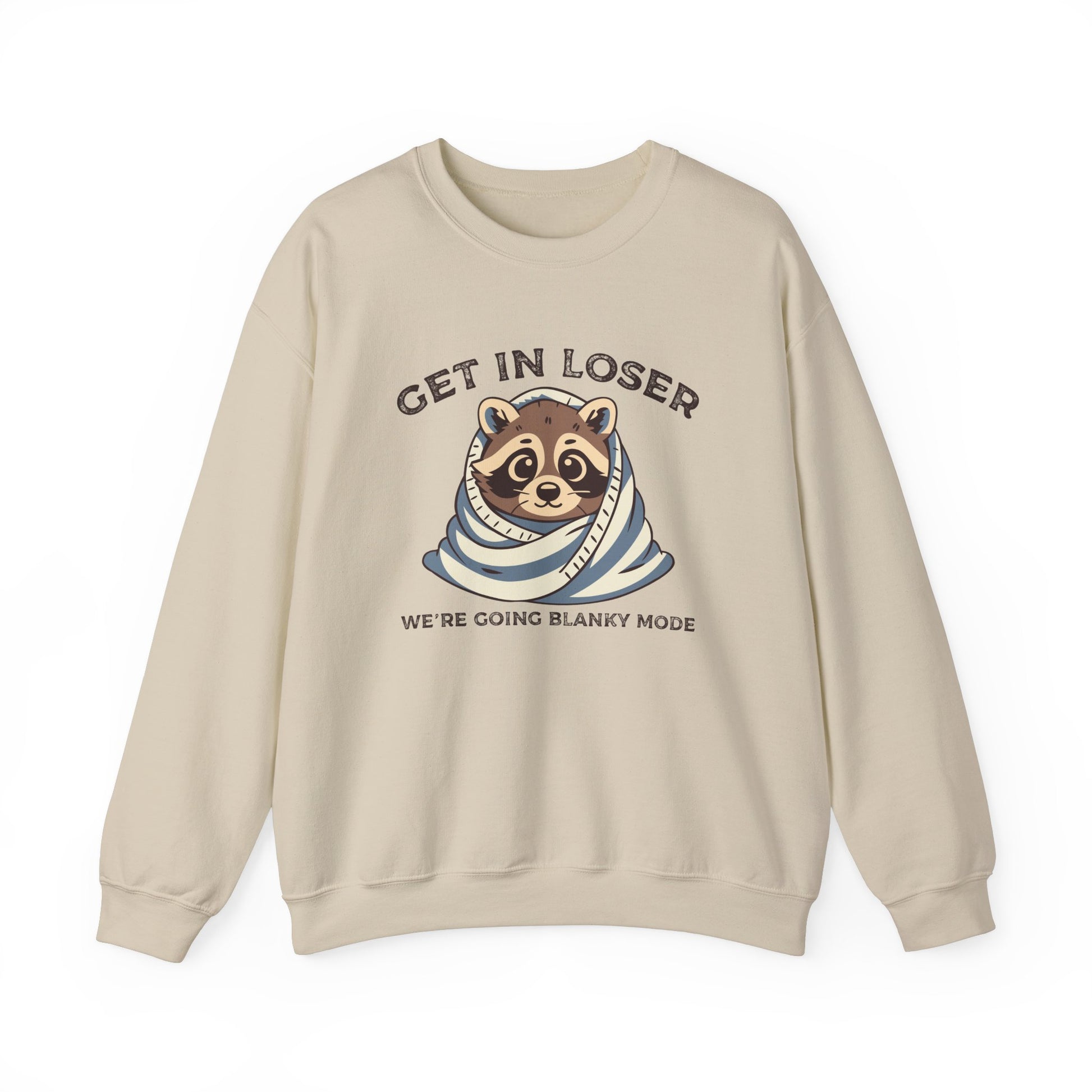 Front view of a beige sweatshirt featuring a raccoon wrapped in a blanket with the text "Get in Loser, We're Going Blanky Mode." Part of the Vivid Divergence Sensory Friendly Unisex Sweater Jumper Range.