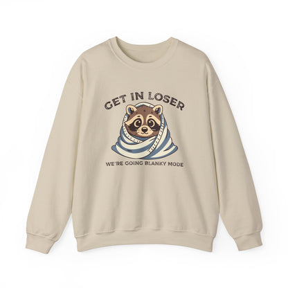 Front view of a beige sweatshirt featuring a raccoon wrapped in a blanket with the text "Get in Loser, We're Going Blanky Mode." Part of the Vivid Divergence Sensory Friendly Unisex Sweater Jumper Range.