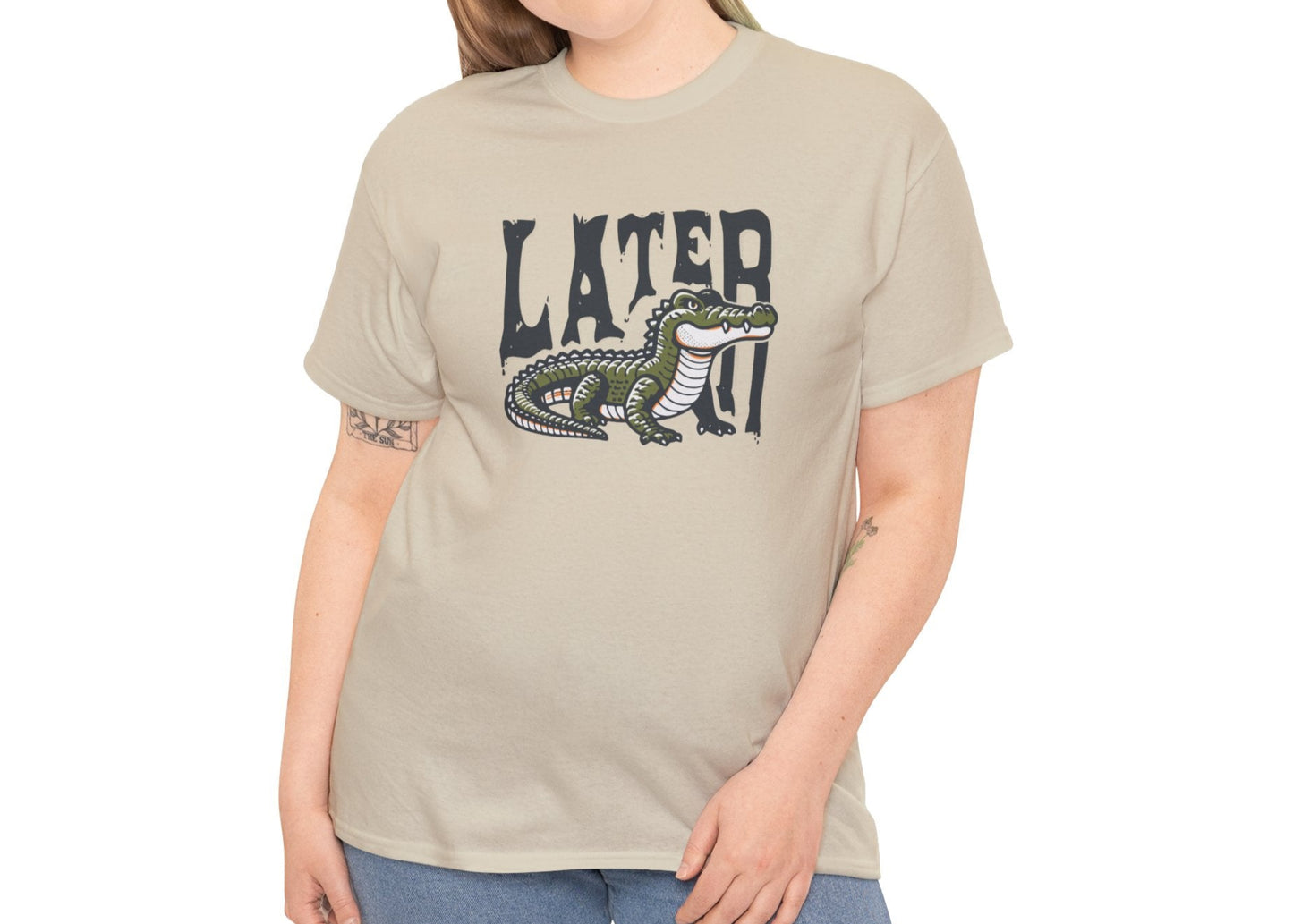 Model wearing a beige T-shirt featuring a "Later Alligator" design with a detailed alligator illustration. Part of the Vivid Divergence Sensory Friendly Unisex Tees Range.