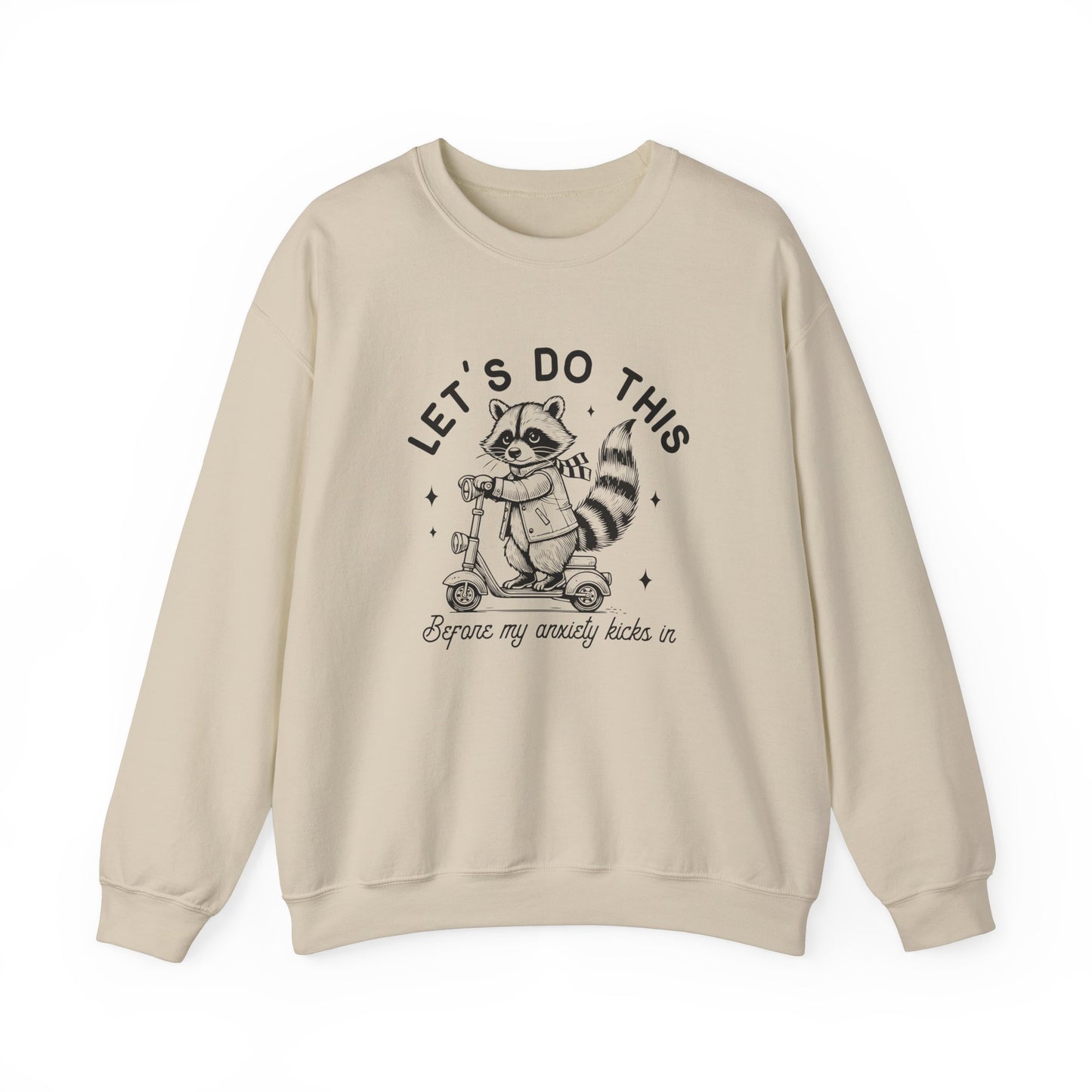 Front view of a beige sweatshirt featuring a cartoon raccoon riding a scooter with the text "Let's Do This Before My Anxiety Kicks In." Part of the Vivid Divergence Sensory Friendly Unisex Sweater Jumper Range.