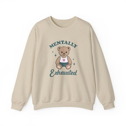 Front view of a beige sweatshirt featuring a cute teddy bear wearing an apron with the text "Mentally Exhausted." Part of the Vivid Divergence Sensory Friendly Unisex Sweater Jumper Range.