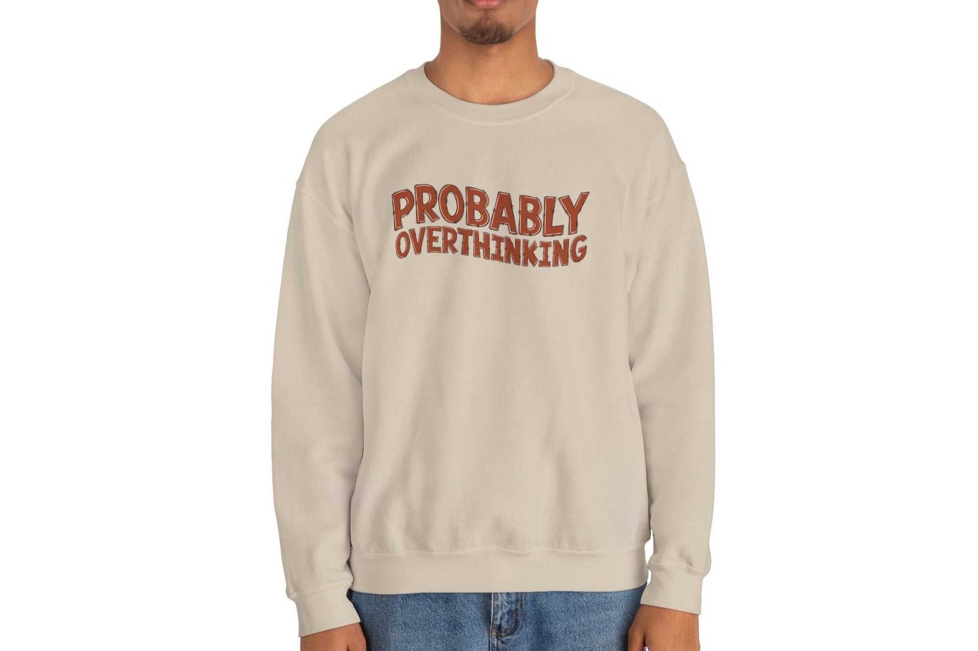 Model wearing a beige sweater jumper with the text "Probably Overthinking" in bold red lettering. Part of the Vivid Divergence Sensory Friendly Unisex Sweater Jumper Range.
