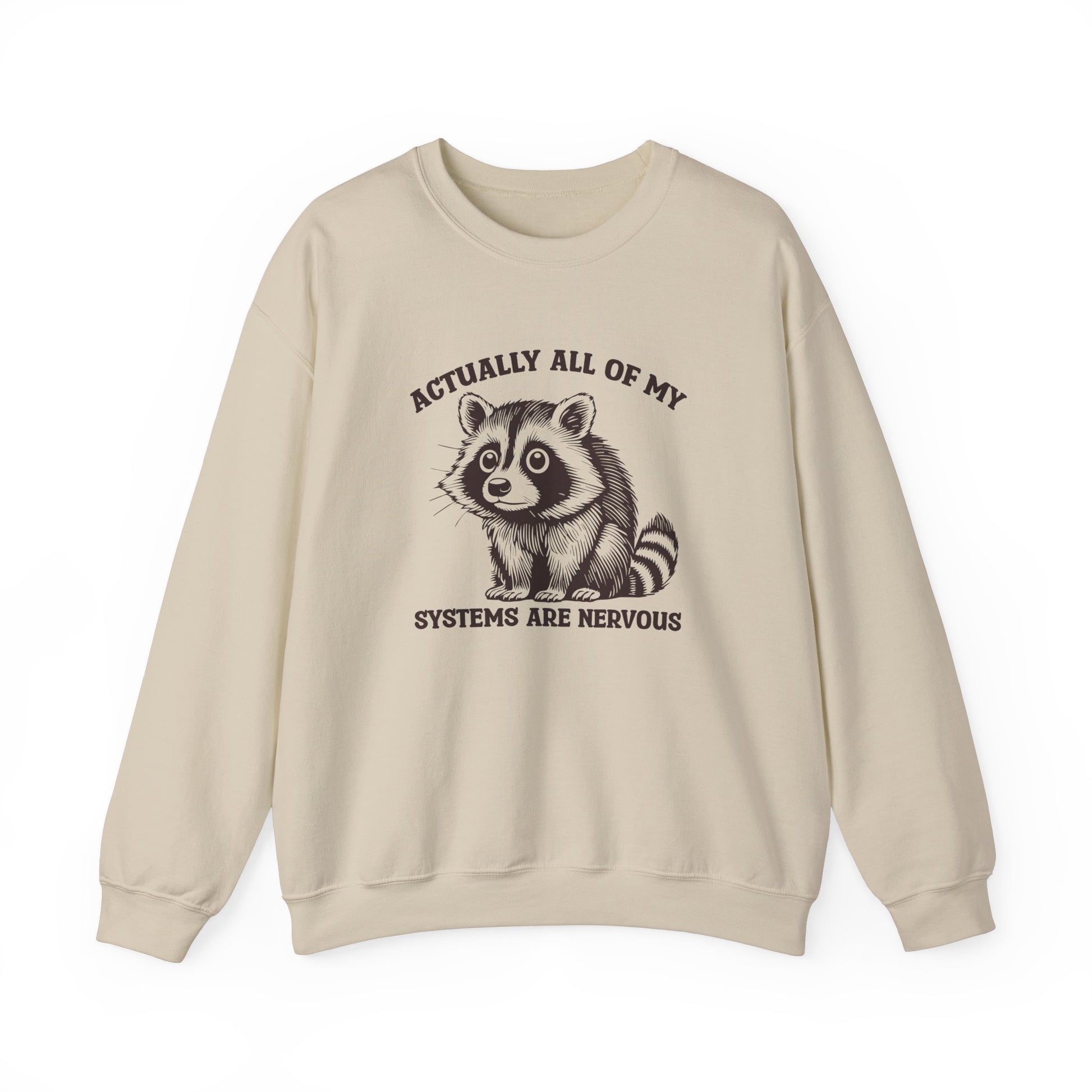 Front view of a beige sweatshirt featuring a raccoon graphic and the text "Actually All of My Systems Are Nervous." Part of the Vivid Divergence Sensory Friendly Unisex Sweater Jumper Range.