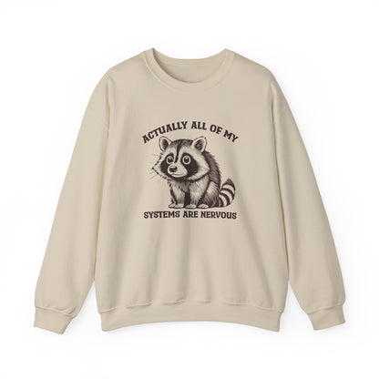 Front view of a beige sweatshirt featuring a raccoon graphic and the text "Actually All of My Systems Are Nervous." Part of the Vivid Divergence Sensory Friendly Unisex Sweater Jumper Range.