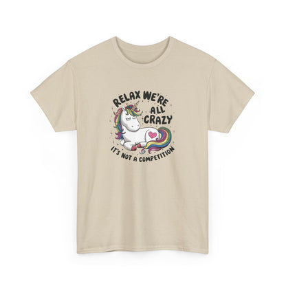 Front view of a beige T-shirt with "Relax, We're All Crazy" and a whimsical cat graphic in black text. Part of the Vivid Divergence Sensory Friendly Unisex Tees Range.