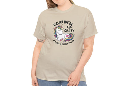 Model wearing a beige T-shirt with "Relax, We're All Crazy" and a whimsical cat graphic in black text. Part of the Vivid Divergence Sensory Friendly Unisex Tees Range.