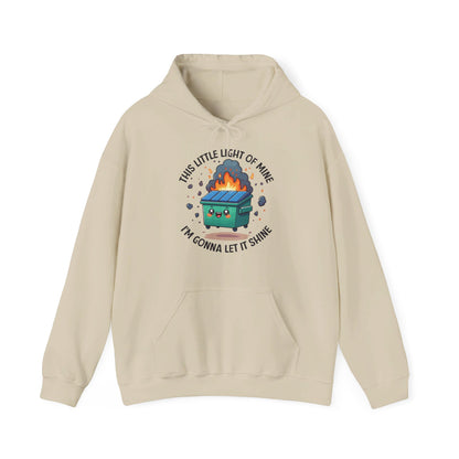 Front view of a beige hoodie featuring the text "This Little Light of Mine, I'm Gonna Let It Shine" and a cartoon illustration of a dumpster fire with glowing flames. Part of the Vivid Divergence Sensory Friendly Unisex Hoodie Range.