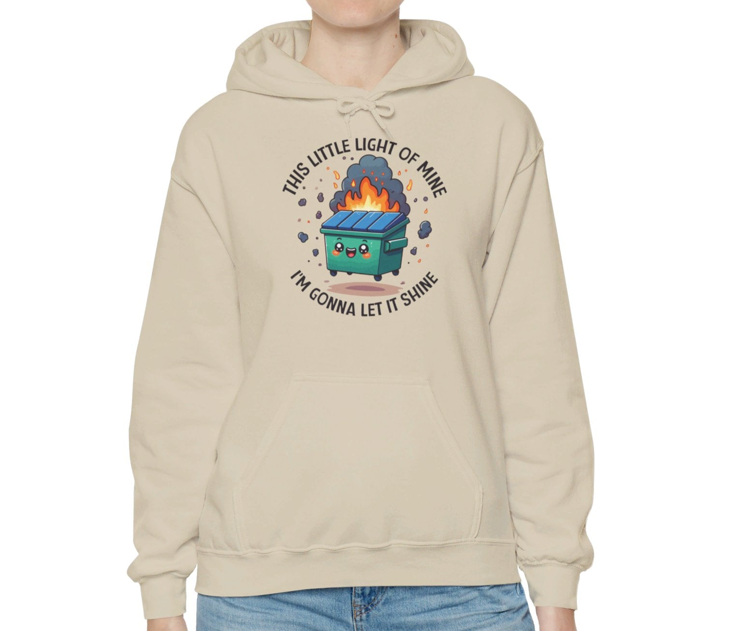 Model wearing a beige hoodie featuring the text "This Little Light of Mine, I'm Gonna Let It Shine" and a cartoon illustration of a dumpster fire with glowing flames. Part of the Vivid Divergence Sensory Friendly Unisex Hoodie Range.