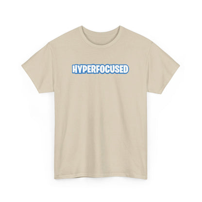 Front view of a beige T-shirt with the text "Hyperfocused" in a Fortnite-style design. Part of the Vivid Divergence Sensory Friendly Unisex Tees Range.