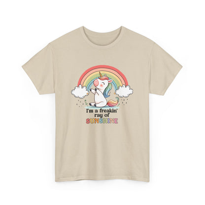 Front view of a beige T-shirt featuring a rainbow and unicorn graphic with the text "I'm A Freakin Ray Of Sunshine." Part of the Vivid Divergence Sensory Friendly Unisex Tees Range.
