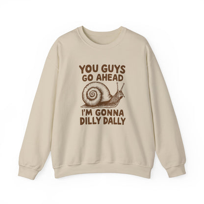 Front view of a beige sweater jumper featuring the text "You Guys Go Ahead, I’m Gonna Dilly Dally" and a cartoon snail illustration. Part of the Vivid Divergence Sensory Friendly Unisex Sweater Jumper Range.