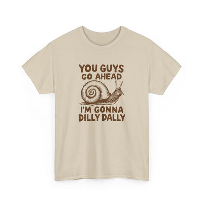 Front view of a beige T-shirt with the text "You Guys Go Ahead, I'm Gonna Dilly Dally" and a playful snail graphic in brown. Part of the Vivid Divergence Sensory Friendly Unisex Tees Range.