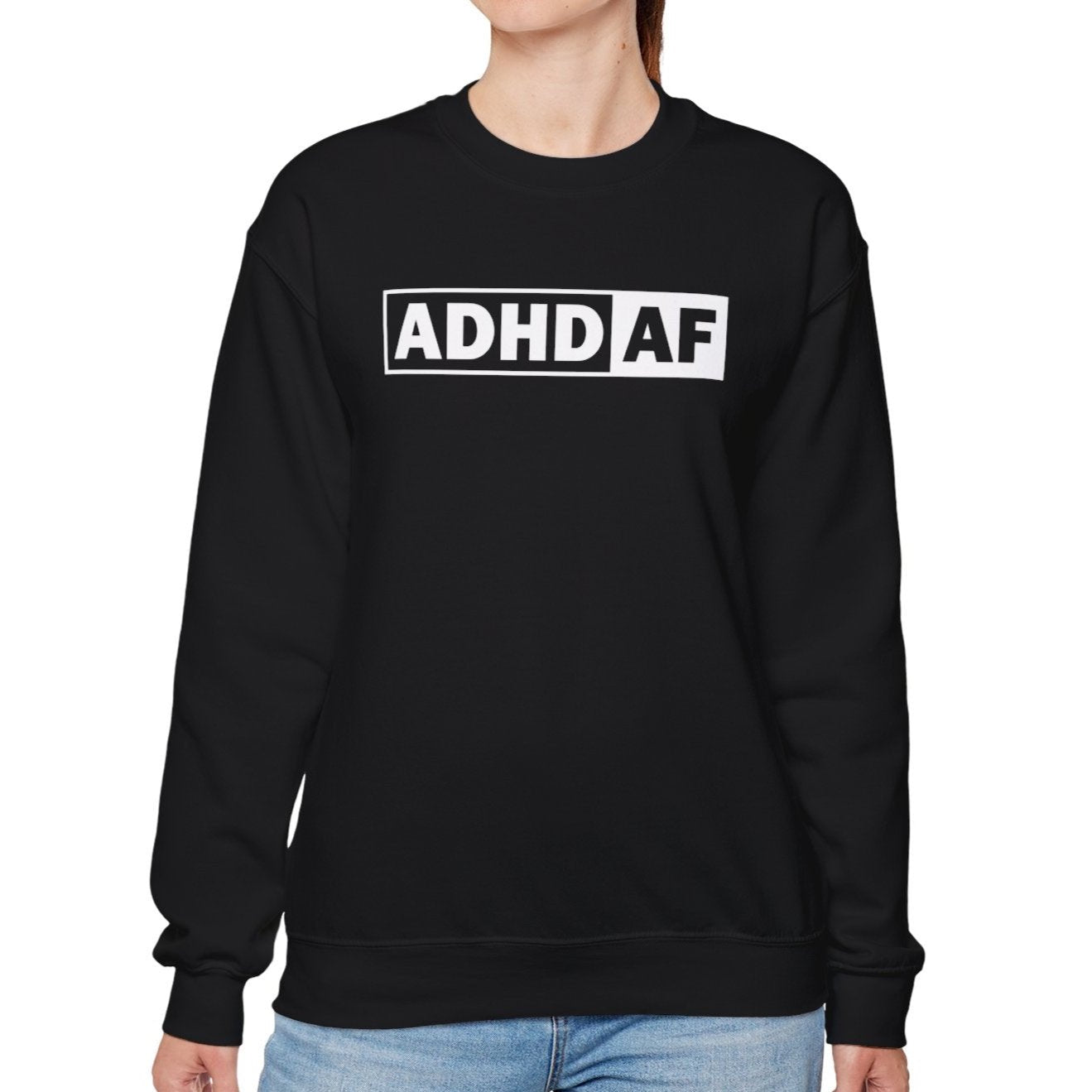 Model wearing a black sweater jumper with "ADHD AF" text in bold white lettering. Part of the Vivid Divergence Sensory Friendly Unisex Sweater Jumper Range.