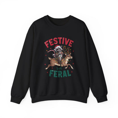 Front view of a black sweatshirt featuring a festive illustration of a raccoon (trash panda) holding Christmas lights and the text "Festive but Feral." Part of the Vivid Divergence Sensory Friendly Unisex Sweater Jumper Range.