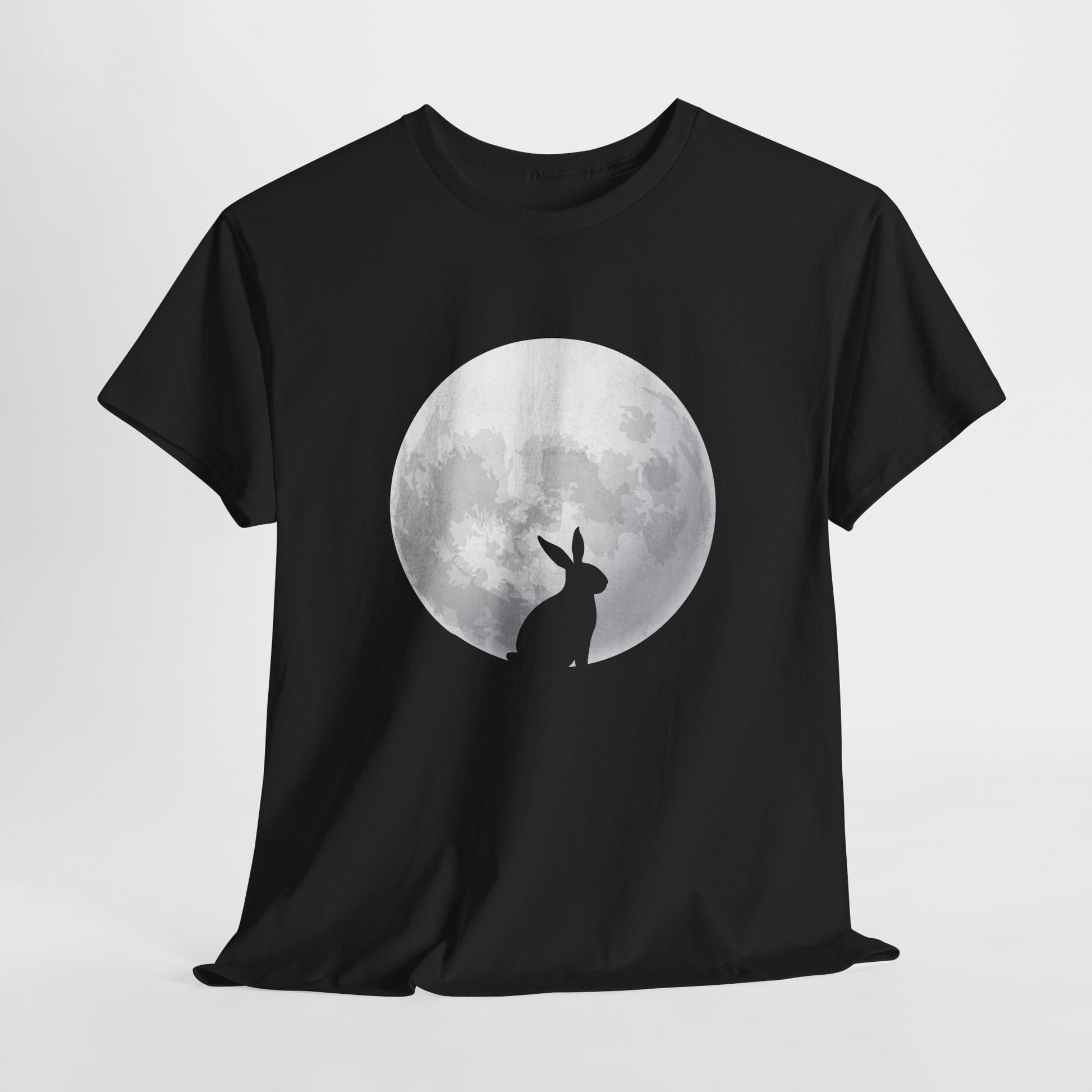 Black T-shirt hanging, featuring a minimalist silhouette of a rabbit against a glowing full moon, perfect for lovers of folklore and moon magic. Hop into the season in style and shop Easter shirts online today!
