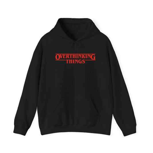 Front view of a black hoodie featuring the text "Overthinking Things" in the iconic Stranger Things font and style. Part of the Vivid Divergence Sensory Friendly Unisex Hoodie Range.